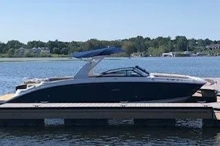 Slide: The Image of 2019 Sea Ray SDX 290 boat docked on a serene lake. - 22