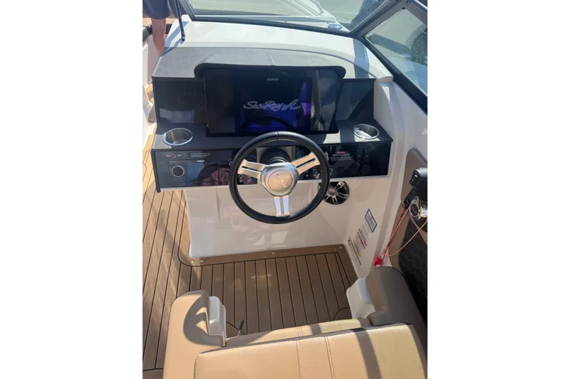 Slide: The Image of 2019 Sea Ray SDX 290 boat helm with steering wheel and dashboard display. - 3
