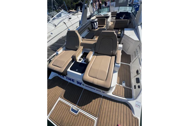Slide: The Image of 2019 Sea Ray SDX 290 boat with tan seating and wooden deck, docked at marina. - 8