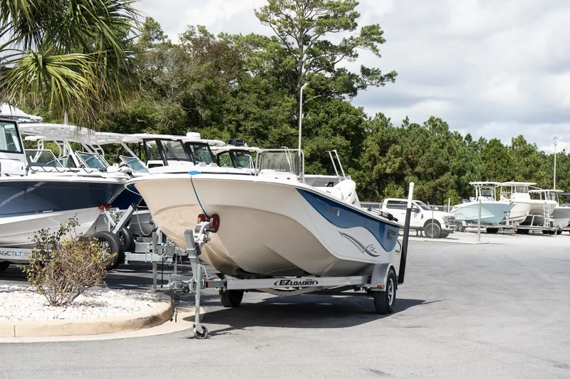Slide: The Image of 2017 Carolina Skiff 218 DLV boat on trailer in marina parking lot. - 3