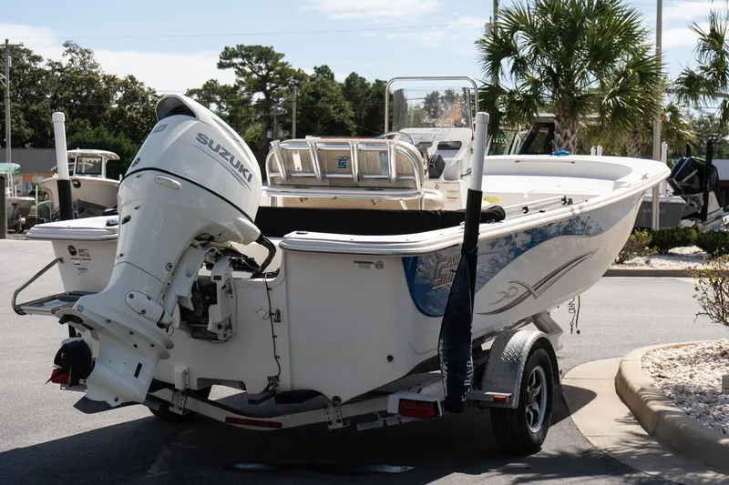 Slide: The Image of 2017 Carolina Skiff 218 DLV boat with Suzuki outboard motor on trailer. - 7