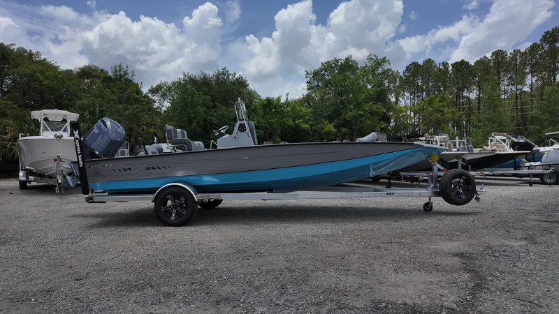 The Image of 2026 Xpress H22B boat on trailer, parked outdoors under cloudy sky. - 0