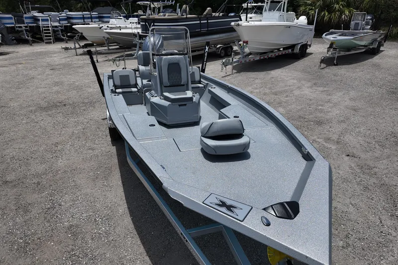 Slide: The Image of 2026 Xpress H22B Bay boat in a marina, surrounded by other boats. - 10