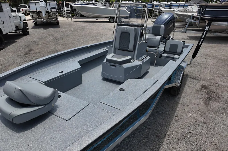 Slide: The Image of 2026 Xpress H22B Bay boat with sleek design and modern seating, parked outdoors. - 11