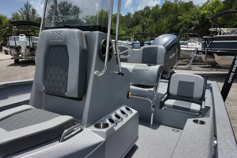 Slide: The Image of 2026 Xpress H22B Bay boat interior with seating and Yamaha engine. - 13