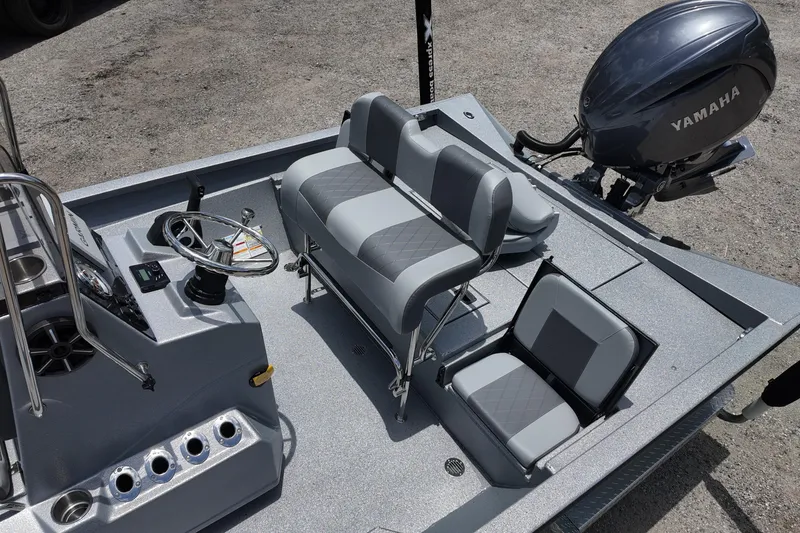 Slide: The Image of 2026 Xpress H22B Bay boat interior with Yamaha motor, featuring modern seating and steering console. - 14