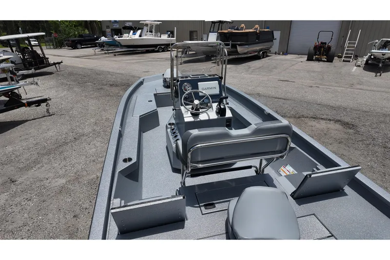 Slide: The Image of 2026 Xpress H22B Bay boat with Garmin system, parked outdoors. - 17