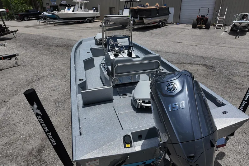 Slide: The Image of 2026 Xpress H22B Bay boat with Yamaha 150 engine in a dealership lot. - 18