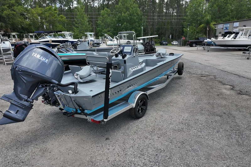 Slide: The Image of 2026 Xpress H22B Bay boat with Yamaha engine on trailer in outdoor lot. - 4