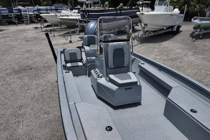 Slide: The Image of 2026 Xpress H22B Bay boat with sleek design, parked among other boats. - 9