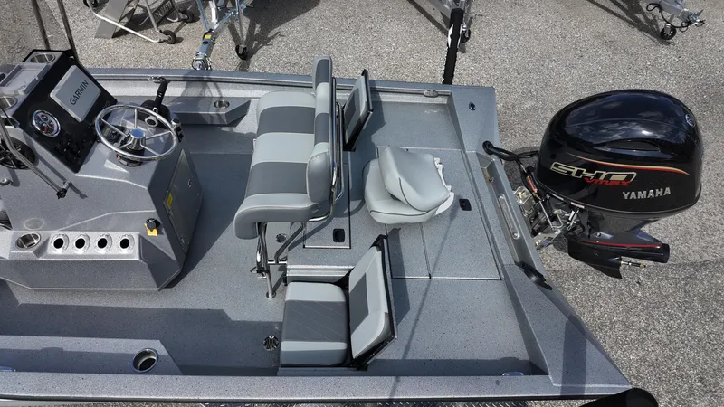 Slide: The Image of 2026 Xpress H20B boat interior with Yamaha engine, featuring seating and Garmin navigation system. - 6