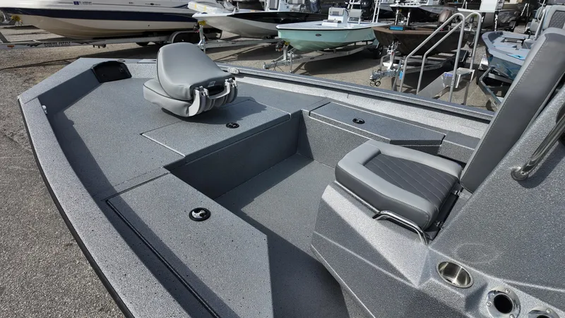 Slide: The Image of 2026 Xpress H20B boat interior with gray seating and storage compartments. - 8
