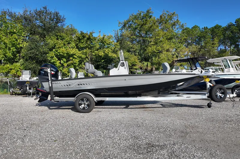 The Image of 2026 Express H20B boat on trailer, parked outdoors with trees in background. - 0