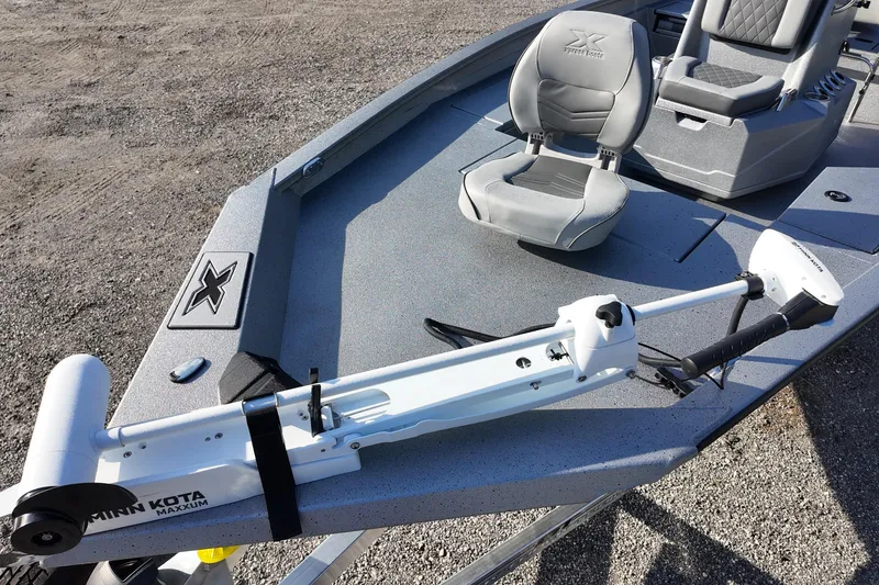 Slide: The Image of 2026 Express H20B boat with Minn Kota Maxxum trolling motor and gray seating. - 11