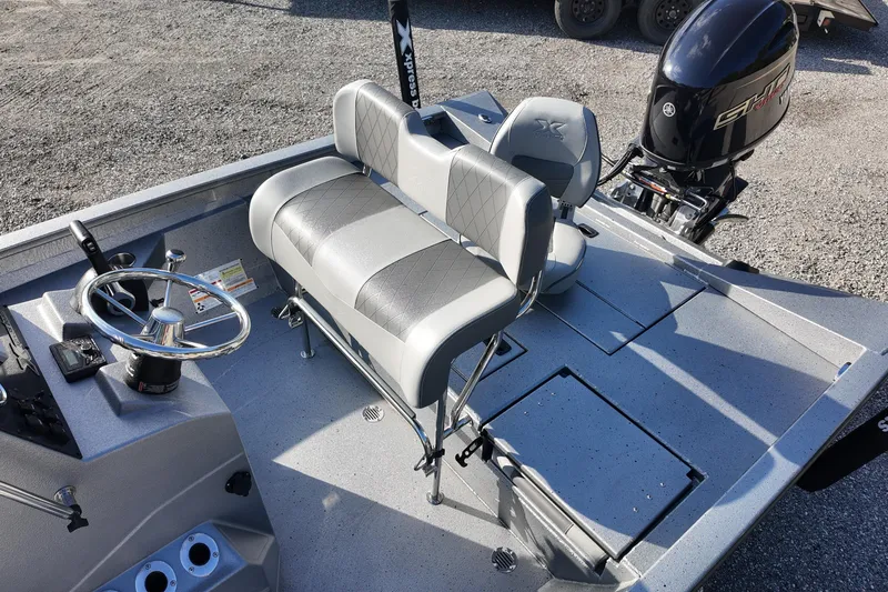 Slide: The Image of 2026 Express H20B boat interior with steering wheel and seating, featuring a powerful outboard motor. - 14