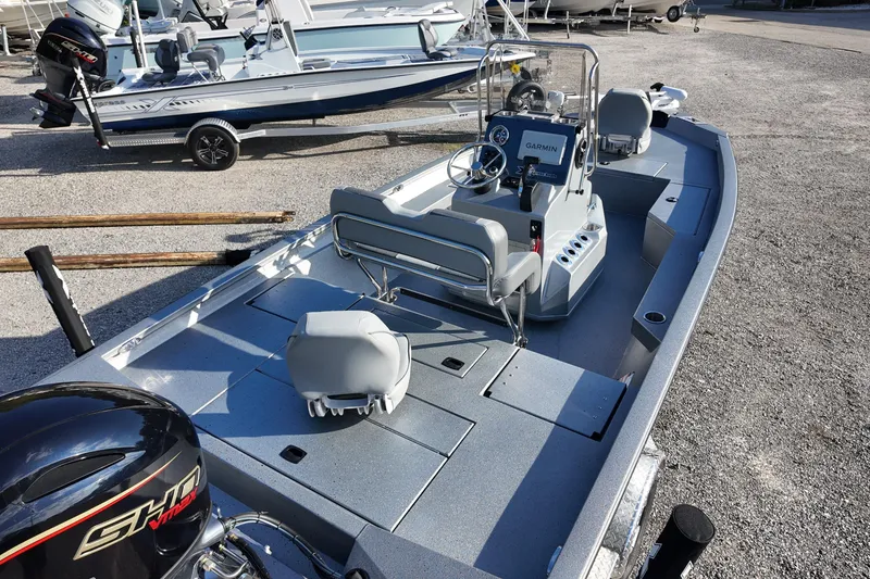 Slide: The Image of 2026 Express H20B boat with modern console and seating, parked on gravel. - 6