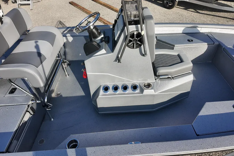 Slide: The Image of 2026 Express H20B boat interior with gray seating and steering console. - 8