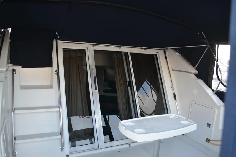 Slide: The Image of 1995 Carver 380 Santego yacht interior with sliding doors and table. - 10