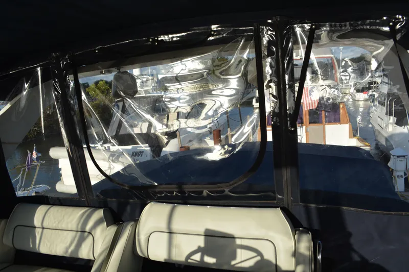 Slide: The Image of Interior view of a 1995 Carver 380 Santego yacht with marina backdrop. - 14