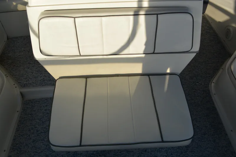Slide: The Image of 1995 Carver 380 Santego boat interior seating with white cushions and gray trim. - 18