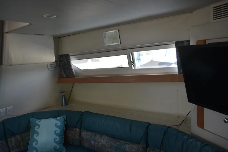 Slide: The Image of Interior of 1995 Carver 380 Santego yacht with seating, window, and TV. - 25