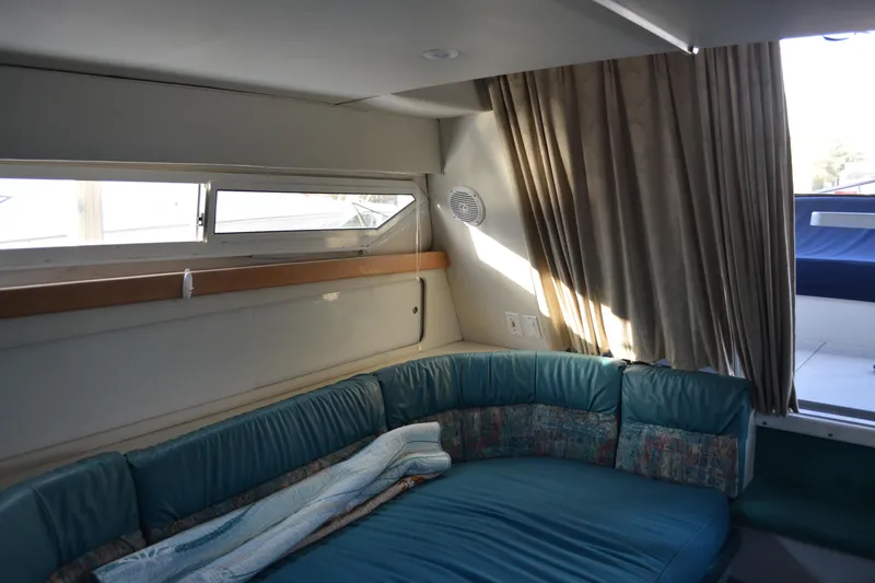 Slide: The Image of Interior of 1995 Carver 380 Santego yacht with teal seating and window view. - 27