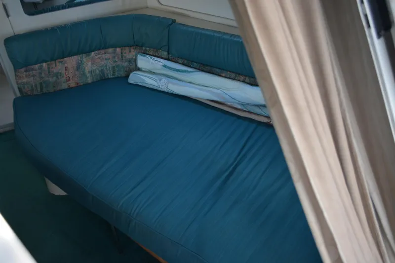 Slide: The Image of Interior cabin of 1995 Carver 380 Santego with blue seating and cushions. - 29