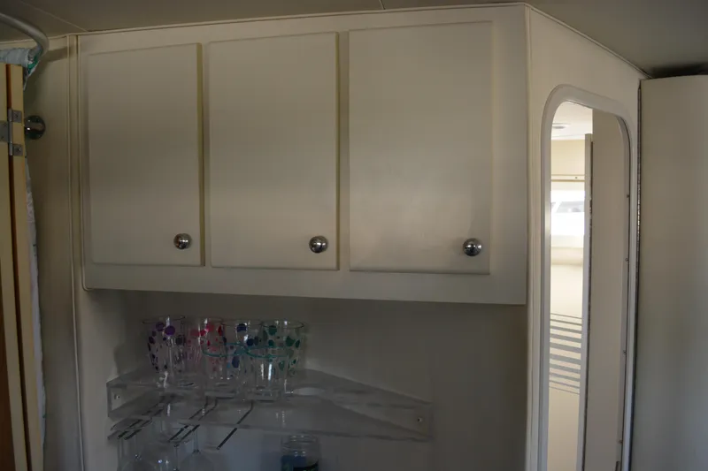 Slide: The Image of Interior of 1995 Carver 380 Santego with cabinets and glassware storage. - 35