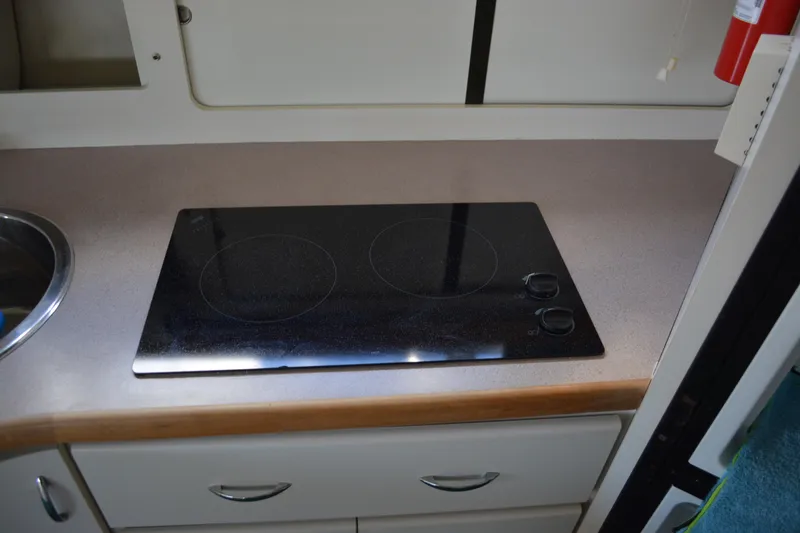 Slide: The Image of 1995 Carver 380 Santego kitchen with sleek electric cooktop and modern cabinetry. - 38