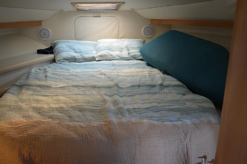 Slide: The Image of Cozy cabin interior of 1995 Carver 380 Santego with bed and soft lighting. - 43