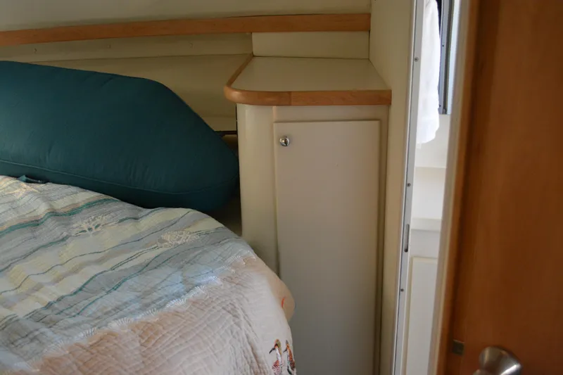Slide: The Image of Cozy cabin interior of 1995 Carver 380 Santego with bed and storage cabinet. - 45
