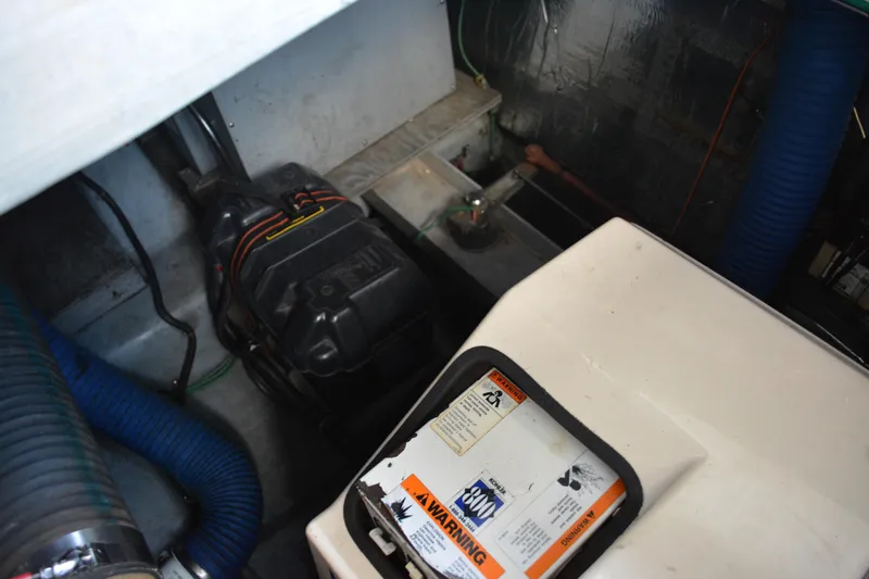 Slide: The Image of Engine compartment of a 1995 Carver 380 Santego boat, featuring mechanical components. - 48