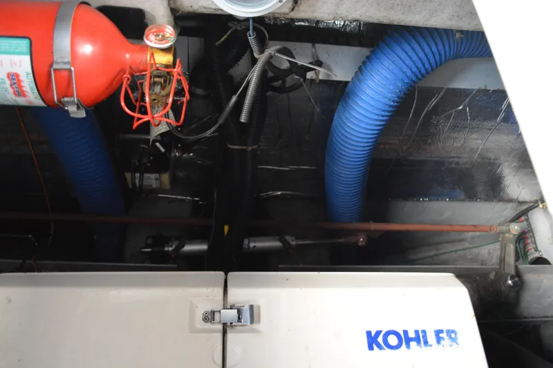 Slide: The Image of Engine compartment of 1995 Carver 380 Santego with Kohler generator and fire extinguisher. - 52