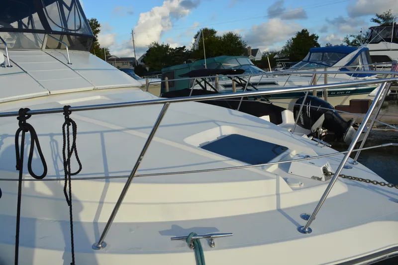 Slide: The Image of 1995 Carver 380 Santego yacht docked, featuring sleek design and stainless steel railings. - 6