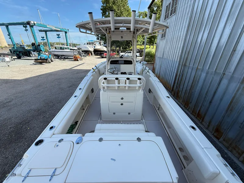 Slide: The Image of 2020 Grady-White Fisherman 257 boat interior, featuring helm and seating, docked at a marina. - 10