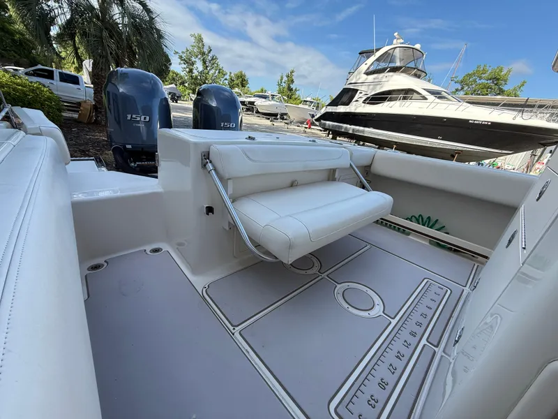 Slide: The Image of 2020 Grady-White Fisherman 257 boat interior with dual Yamaha 150 engines, docked under blue sky. - 12