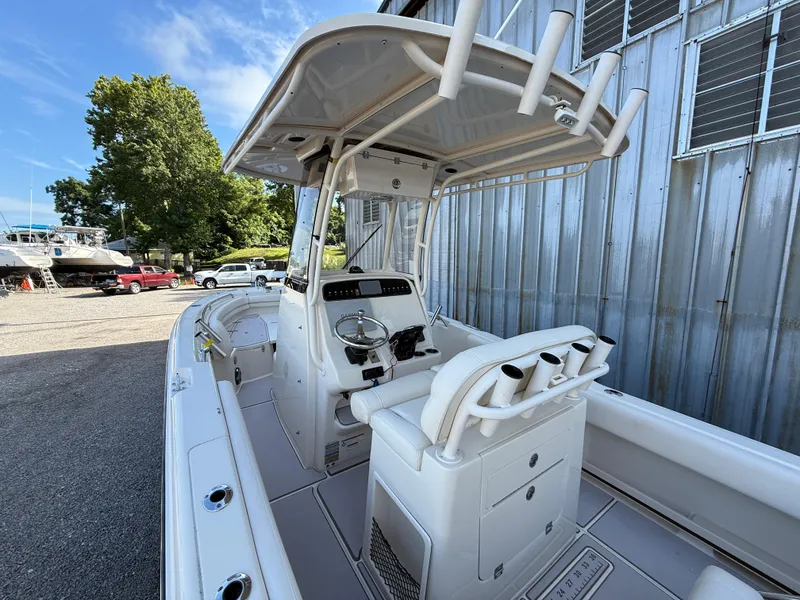 Slide: The Image of 2020 Grady-White Fisherman 257 boat interior with helm and seating, docked outdoors. - 15
