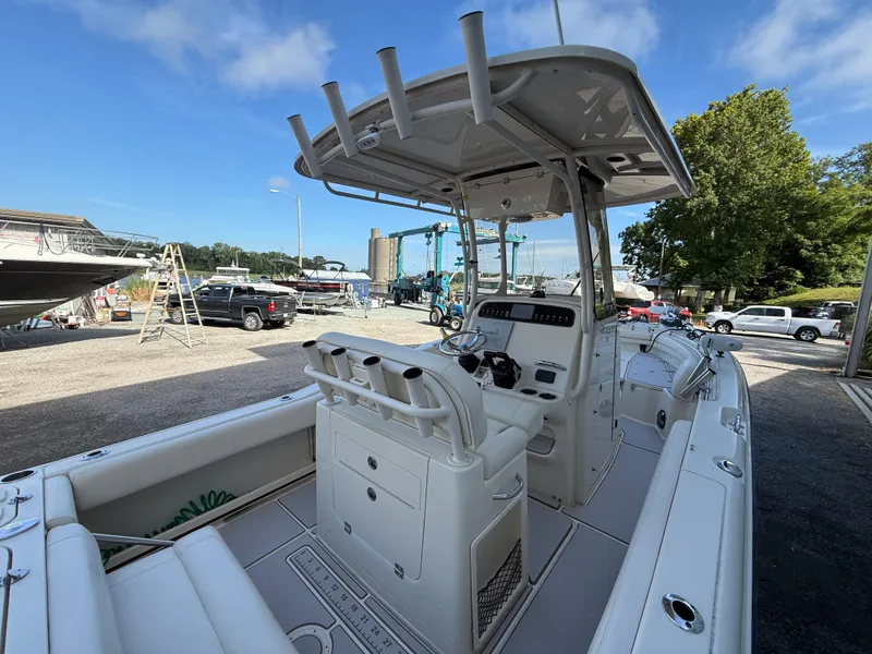 Slide: The Image of 2020 Grady-White Fisherman 257 boat docked, featuring a spacious deck and modern console. - 16