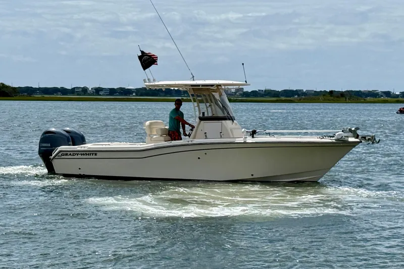 Slide: The Image of 2020 Grady-White Fisherman 257 boat cruising on a calm lake with a person onboard. - 2