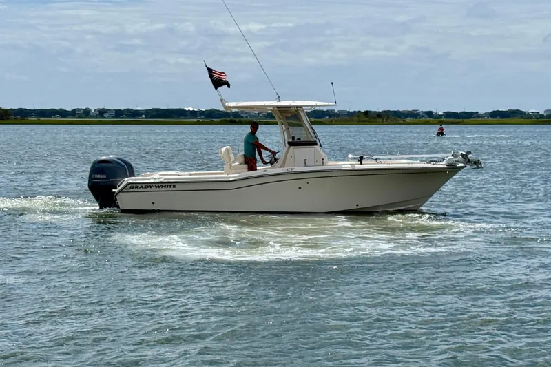 Slide: The Image of 2020 Grady-White Fisherman 257 boat cruising on a calm waterway. - 5