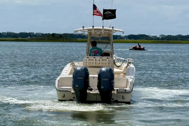 Slide: The Image of 2020 Grady-White Fisherman 257 boat cruising on a lake with American flag. - 6