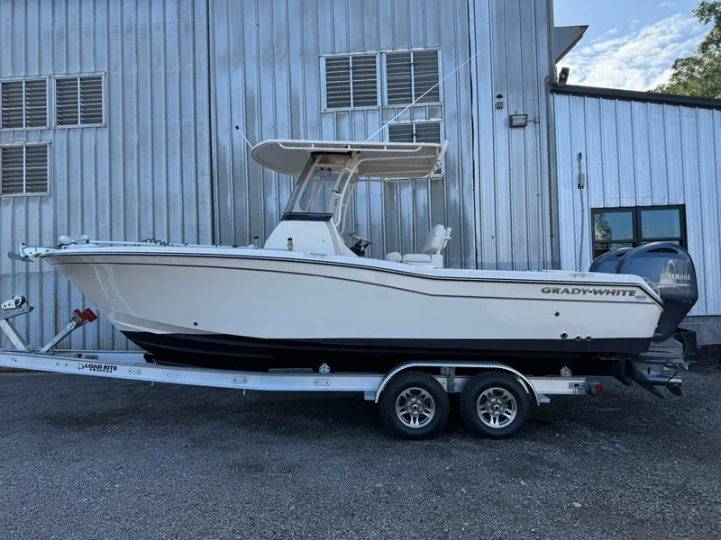 Slide: The Image of 2020 Grady-White Fisherman 257 boat on trailer, parked beside a metal building. - 7