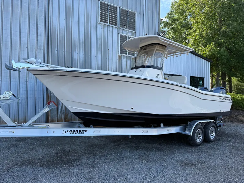 Slide: The Image of 2020 Grady-White Fisherman 257 boat on trailer, parked near metal building. - 8