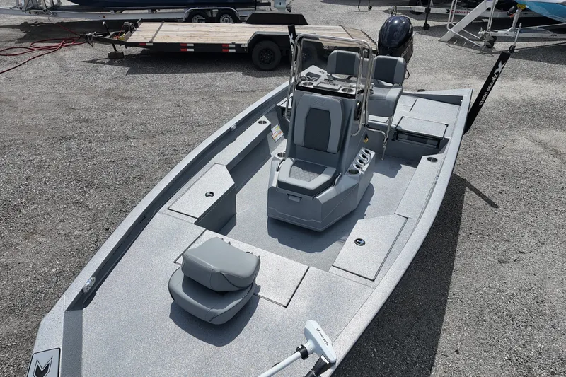 Slide: The Image of 2026 Express H20B Bay boat with sleek design and modern features, parked on gravel. - 11