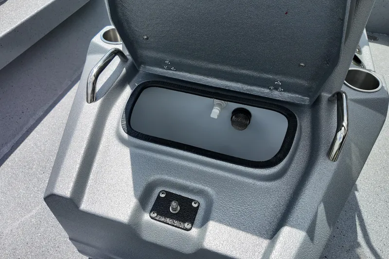 Slide: The Image of Open storage compartment on 2026 Express H20B Bay boat with cup holders. - 14