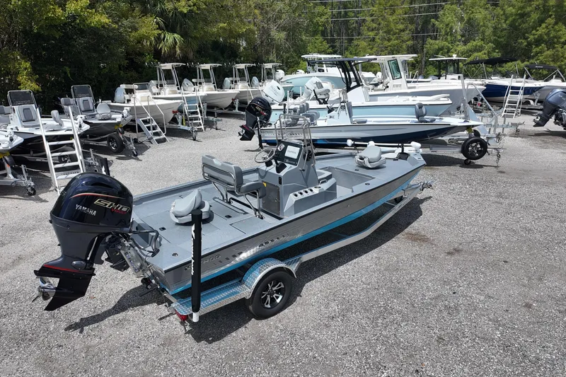 Slide: The Image of 2026 Express H20B Bay boat with Yamaha engine in a dealership lot. - 5