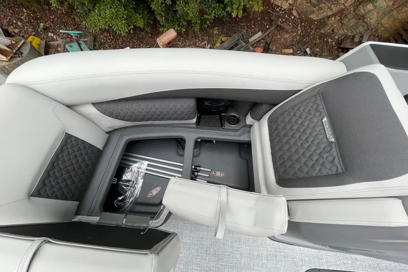 Slide: The Image of 2026 Harris Sunliner 210 boat interior with gray quilted seating and storage compartments. - 11