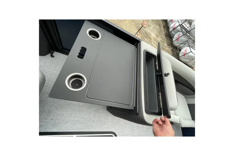 Slide: The Image of 2026 Harris Sunliner 210 boat interior with cup holders and storage compartment. - 13