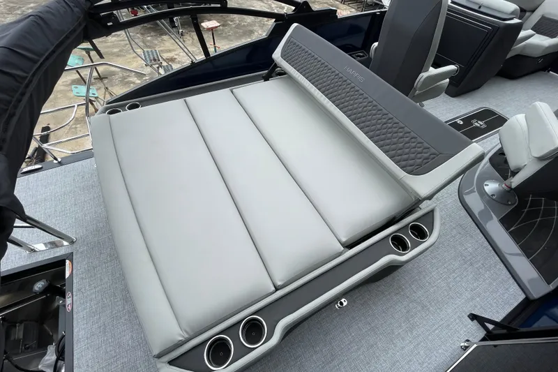 Slide: The Image of 2026 Harris Sunliner 210 boat interior with luxurious seating and cup holders. - 17