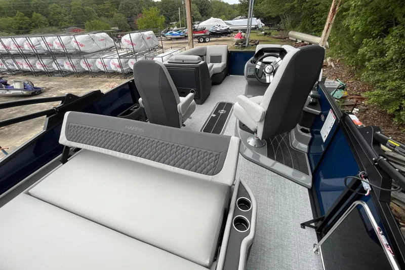 Slide: The Image of 2026 Harris Sunliner 210 pontoon boat interior with modern seating and steering console. - 19